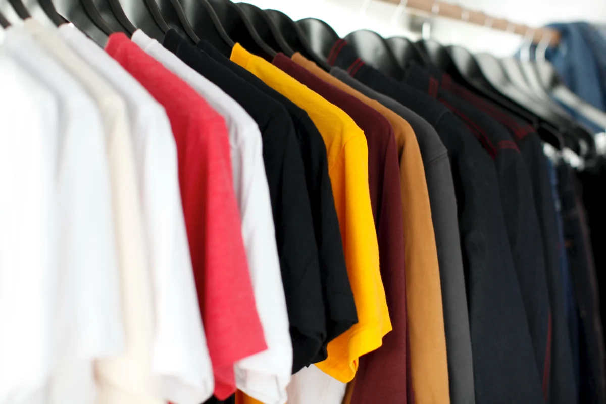 Different coloured t-shirts hung in a hanger.Top Best Ways to Style a Shirt 2023